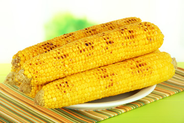 Delicious golden grilled corn  on table on bright background
