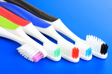 Tooth-brushes on blue background