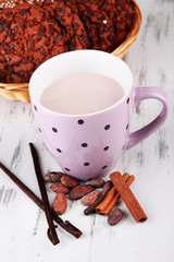 Cocoa drink  with spices and cookies on wooden background