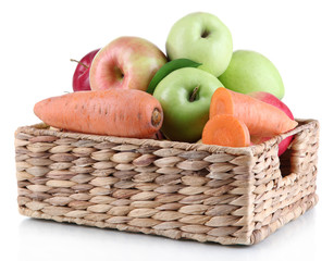 Sweet apples and carrots in basket isolated on white