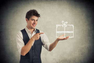 Young man pointing a gift