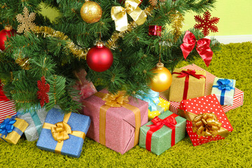 Decorated Christmas tree with gifts close-up