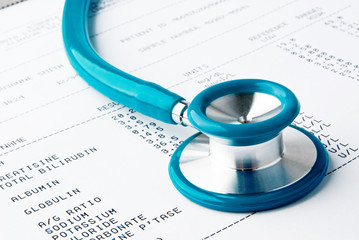 Blood test results in a clipboard with stethoscope