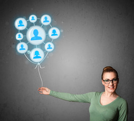 Woman holding social network balloon