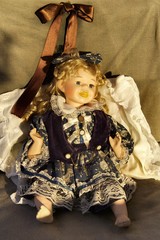 A doll dressed with vintage clothes