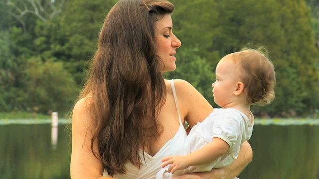Close Up Caucasian Mom Kiss Baby Daughter