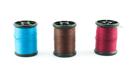 colored bobbins of silk threads on a coils isolated on white