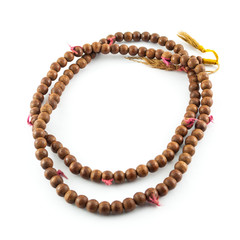 Old or vintage wooden rosary beads isolated on white
