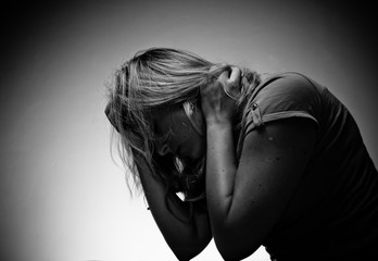 sad woman sitting alone in a empty room
