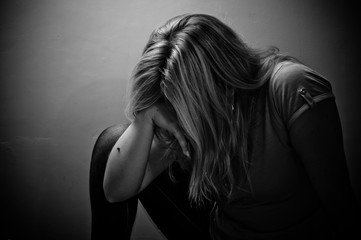 sad woman sitting alone in a empty room