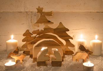 Frohe Weihnachten: Holzkrippe mit Kerzenlicht