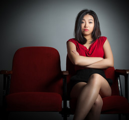 Attractive Asian girl 20s at the theatre isolate white backgroun