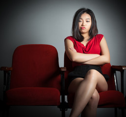 Attractive Asian girl 20s at the theatre isolate white backgroun