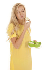 Woman hold cucumber eyes closed