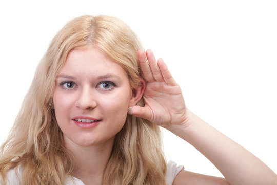 woman eavesdropping with hand behind her ear