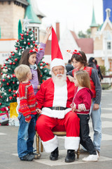 Children Playing With Santa Claus's Hat