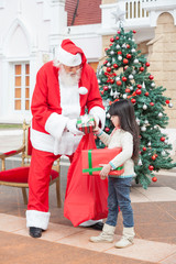 Girl Taking Presents From Santa Claus
