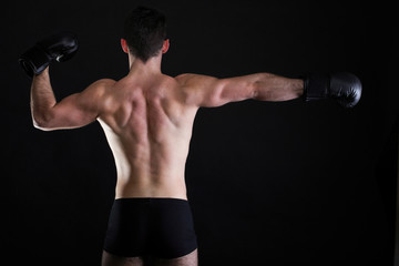 Portrait sportsman boxer in studio dark background