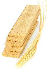 Oat biscuits and wheat ears isolated on white
