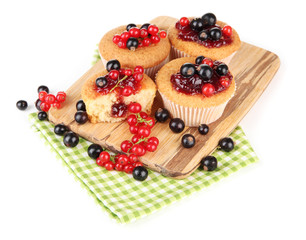 Tasty muffins with berries isolated on white