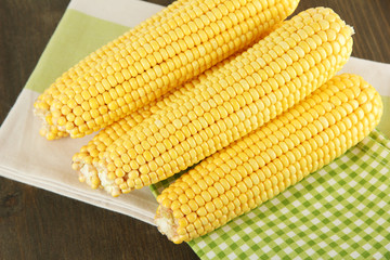 Crude corns on napkin on wooden table