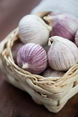 Close-up of chinese solo garlic in a wicker basket, studio shot
