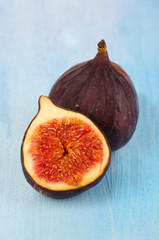 Ripe figs on blue wooden table close-up