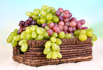 Ripe green and purple grapes in basket