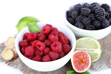 Raspberries and blackberry in small bowls