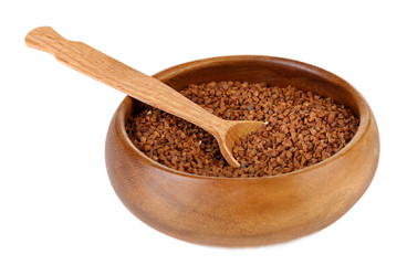 Buckwheat groats in bowl and wooden spoon isolated on white