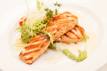 Grilled salmon steak with salad