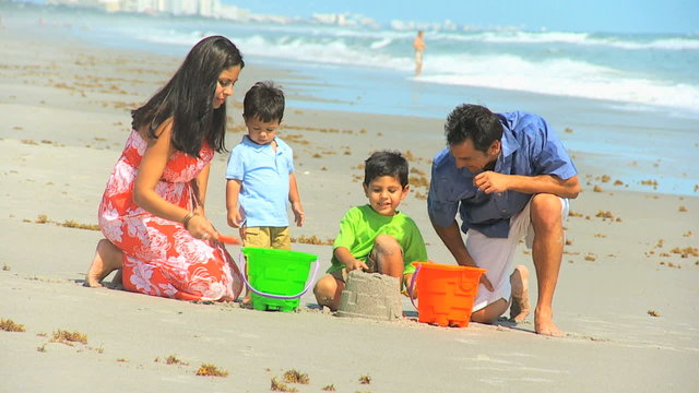 Young Hispanic Family Playing Sand Beach Outing