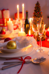 Cutlery with red ribbon on the holiday table