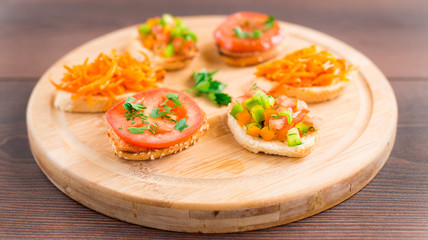 Delicious bruschetta with vegetables and herbs