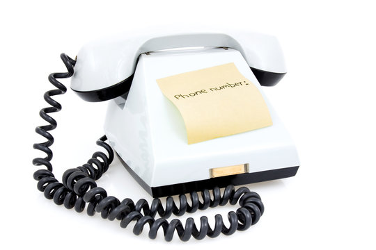 White telephone with sticky note