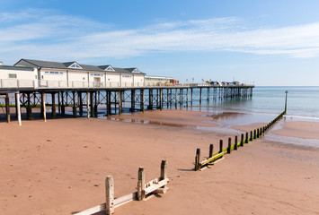 English Pier with blue sky and sandy beach