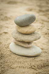 Fototapeta na wymiar Stones piled up on a sand beach