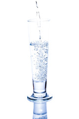 water pouring in a glass on white background.