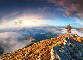 Photographer takes a sunset in the mountains