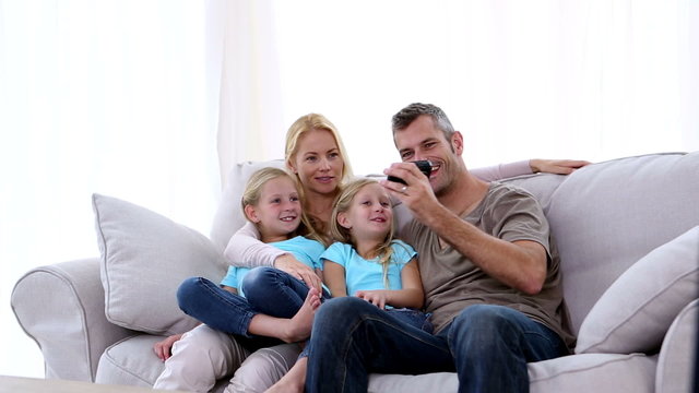 Father taking self portrait of him with family