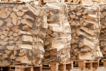 Packed stacks of fire wood laying on palettes