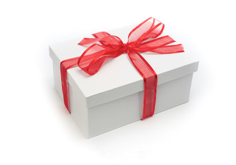 Christmas present wrapped with a red ribbon and bow.