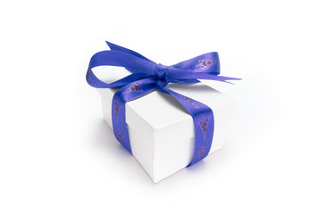 Christmas present wrapped with a blue ribbon and bow.
