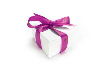 Obraz premium Christmas present wrapped with a pink ribbon and bow.