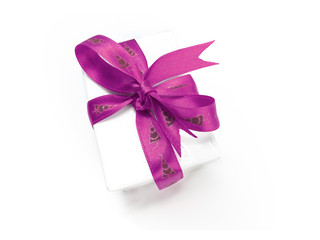 Christmas present wrapped with a pink ribbon and bow.