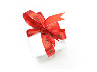 Christmas present wrapped with a red ribbon and bow.