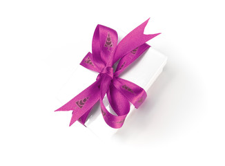 Christmas present wrapped with a pink ribbon and bow.