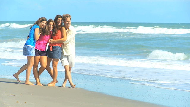Happy Caucasian Family Group Running Beach