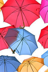 Colorful umbrellas over sky