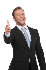 Happy businessman. Cheerful young businessman looking at camera